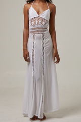 akoiaswim White dress with crochet details on a plain background